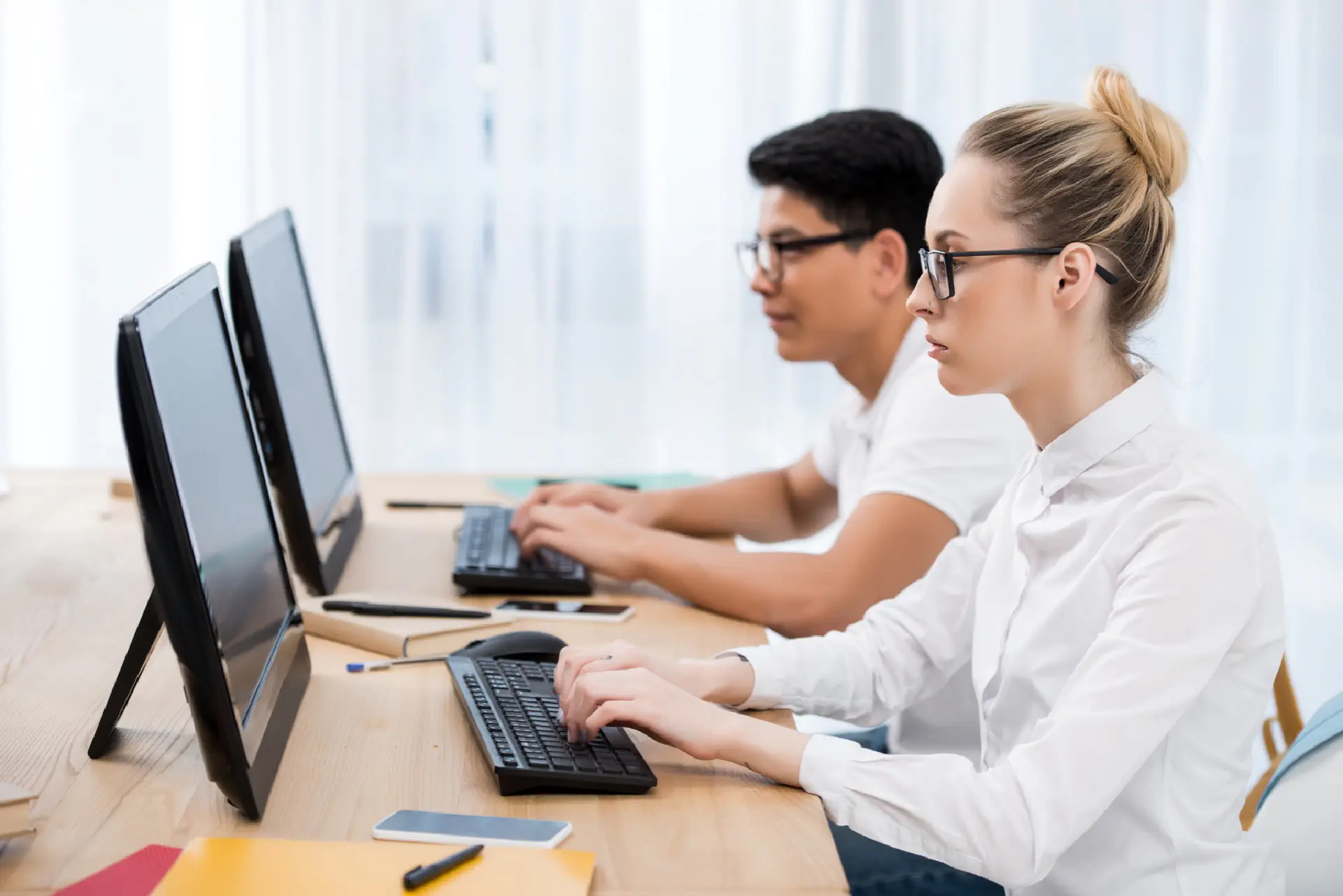 Two Students Looking At Blank Computer Screens