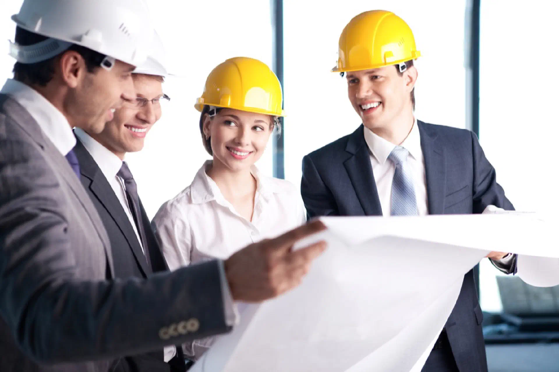 Business People With Hardhats Having A Meeting