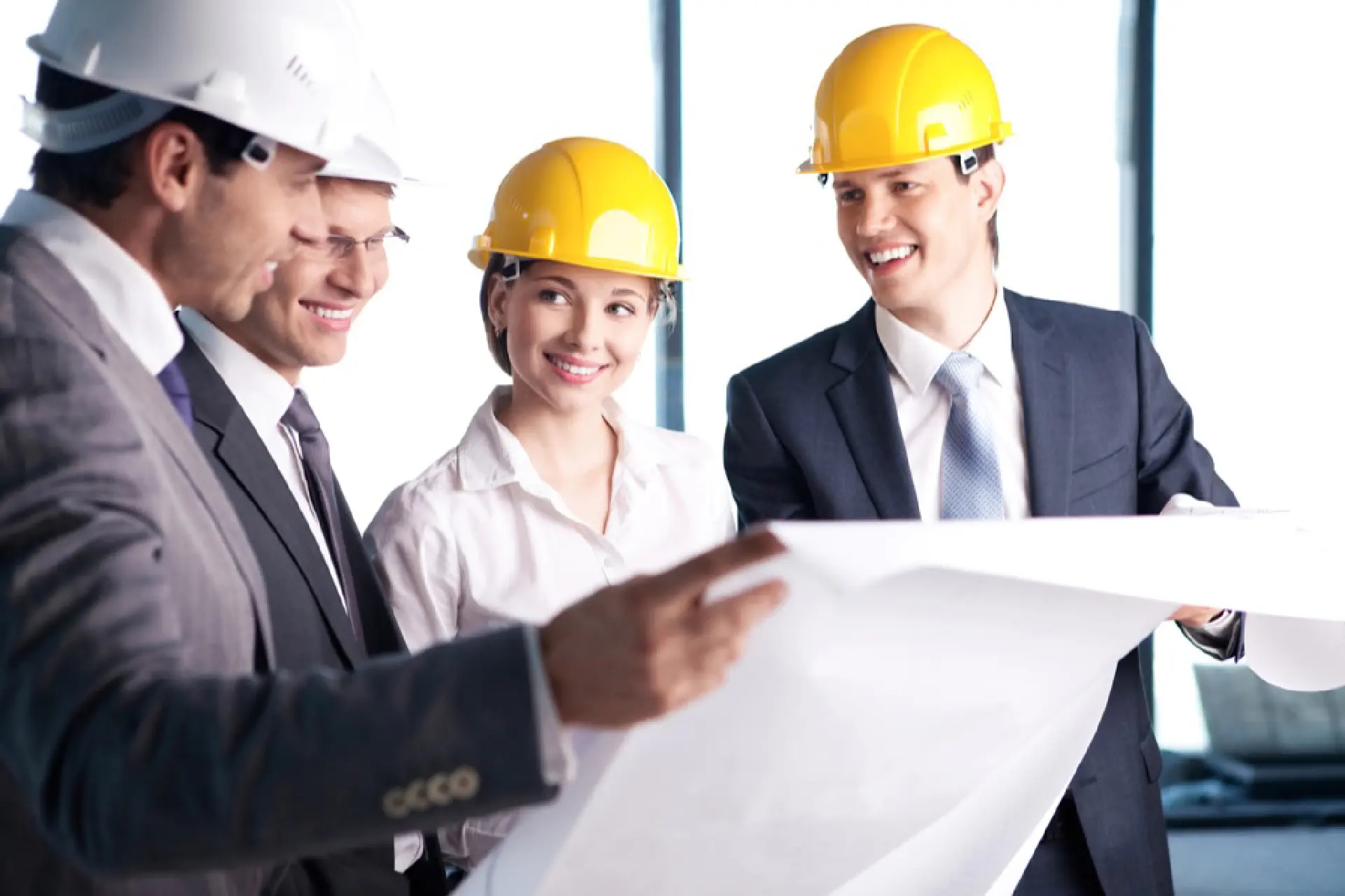 Business People With Hardhats Having A Meeting