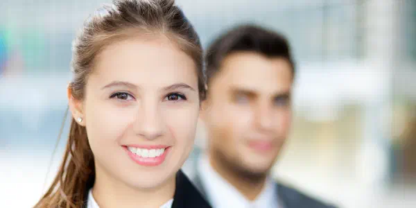 A Business Lady With A Man In The Background