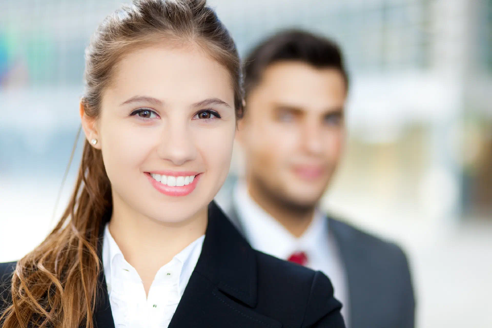 A Business Lady With A Man In The Background