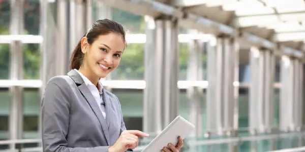 A Smiling Woman With A Tablet